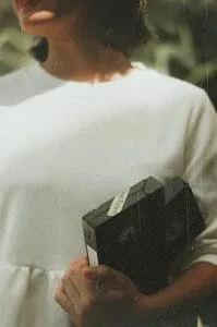 VHS_videoband Kvinna håller i VHS videokassetter
